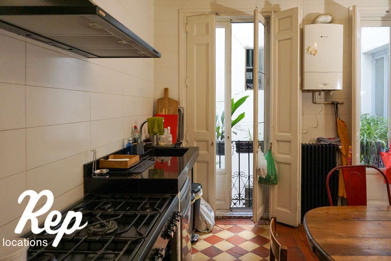 Black kitchen with white windows